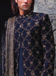 Black silk fully embroidered sherwani with antique gold embroidery and crushed silk stole.